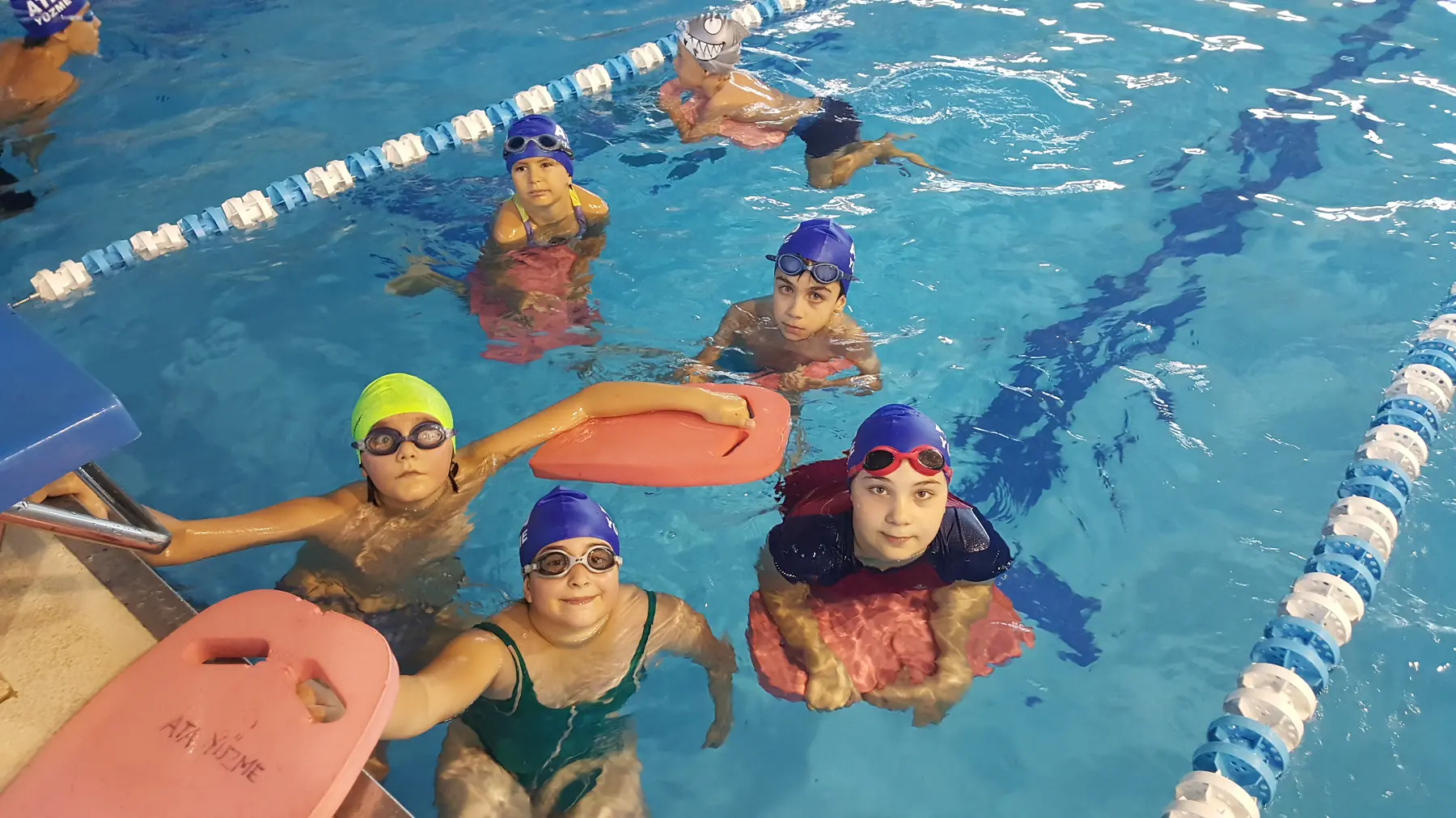 Group of children running with swimming boards