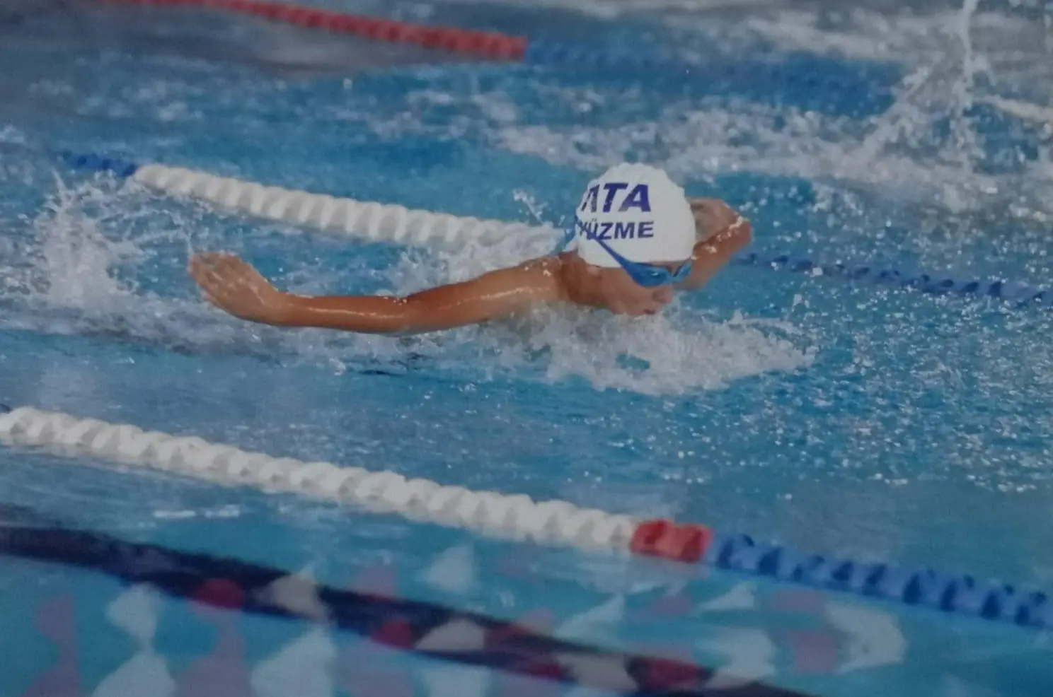 Young athlete swimming butterfly style