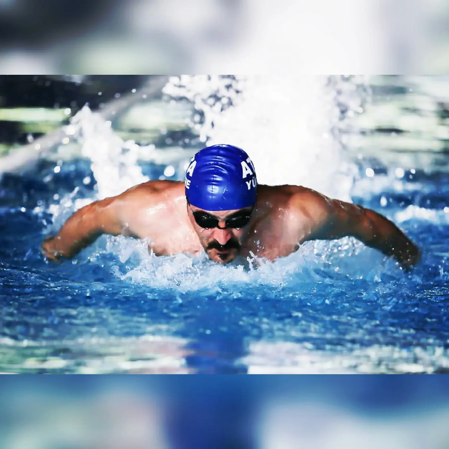 Athlete swimming in butterfly style